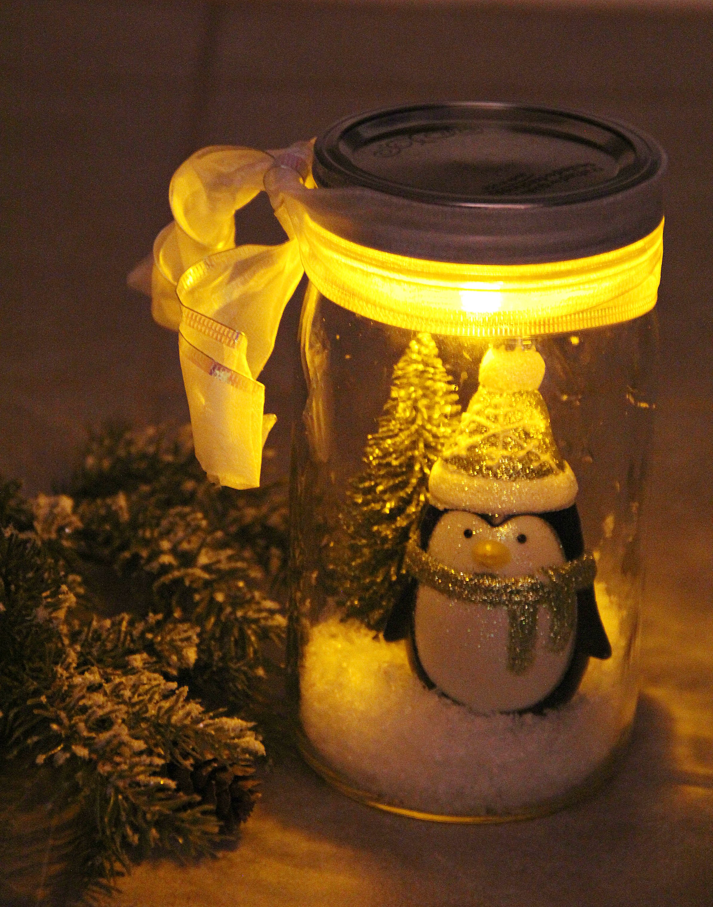 Illuminated Snow Scene in a Jar - An LED tea light illuminates a decorative winter scene inside of a mason jar. Such an easy and beautiful decoration for winter and Christmas!