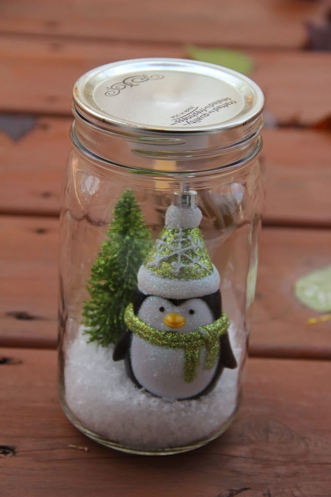 Illuminated Snow Scene in a Jar - An LED tea light illuminates a decorative winter scene inside of a mason jar. Such an easy and beautiful decoration for winter and Christmas!