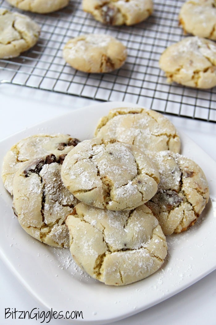 Candy Bar Cookies - Soft and simple cake mix cookies filled with chocolate candy bar pieces and rolled in powdered sugar.