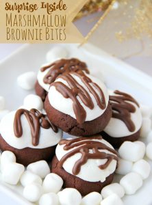Surprise Inside Marshmallow Brownie Bites - Bite-sized brownie cookies filled with a caramel center and topped with marshmallow and chocolate drizzle!