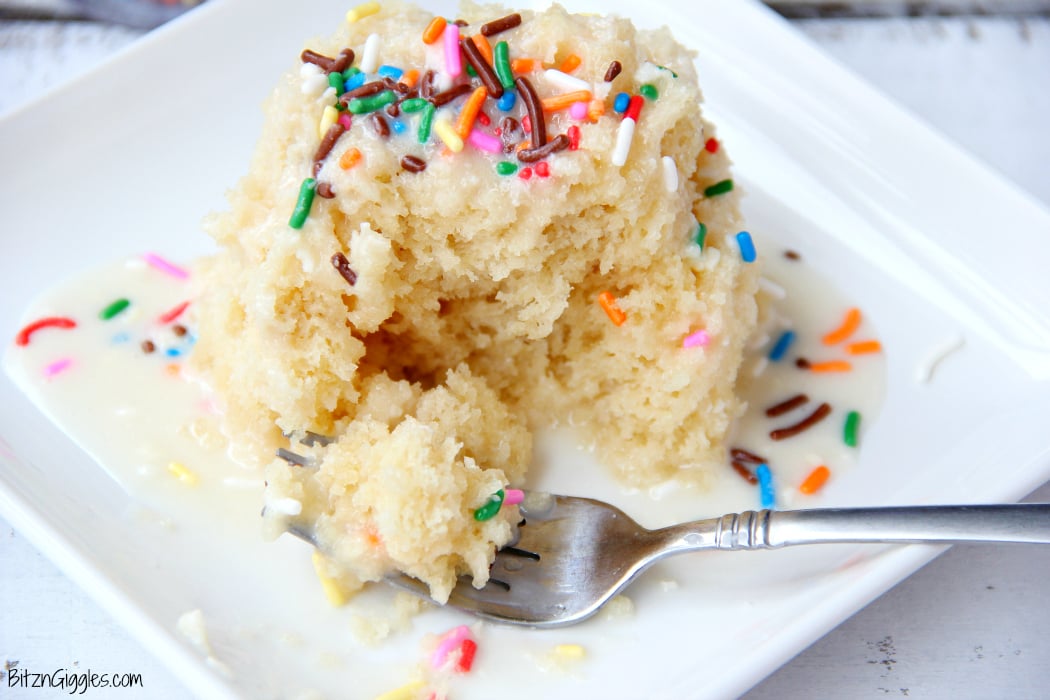 Vanilla Mug Cake - Ready in 90 seconds! This mug cake is moist, delicious and topped with a lovely vanilla icing that soaks into the cake and infuses it with sweetness! #mugcake #vanillacake #recipe #easymugcake #microwavedessert #bitzngiggles