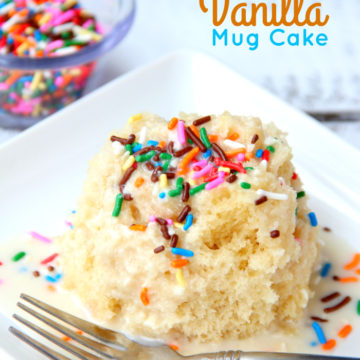 Easy Vanilla Mug Cake - Ready in 90 seconds! This mug cake is moist, delicious and topped with a lovely vanilla icing that soaks into the cake and infuses it with sweetness! #mugcake #vanillacake #recipe #easymugcake #microwavedessert #bitzngiggles