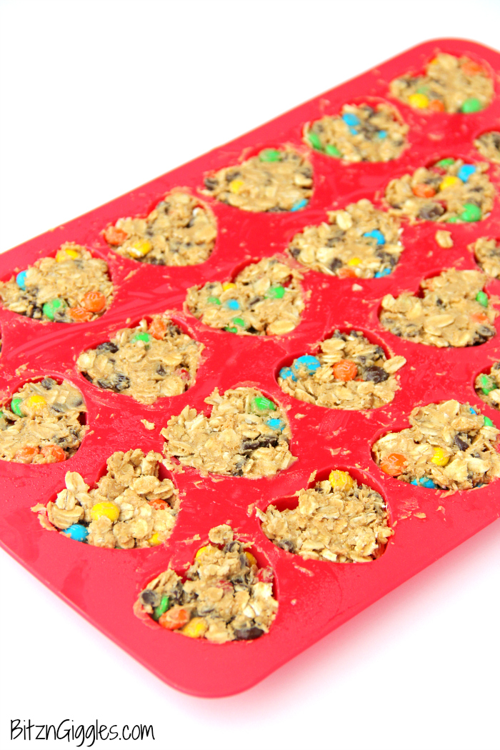 M&M Granola Bites - These granola bites are a family favorite, made with peanut butter, honey, M&Ms and chocolate chips! I used a silicone pan with heart-shaped molds to make a creative Valentine's Day dessert. Use any kind of mold you like!