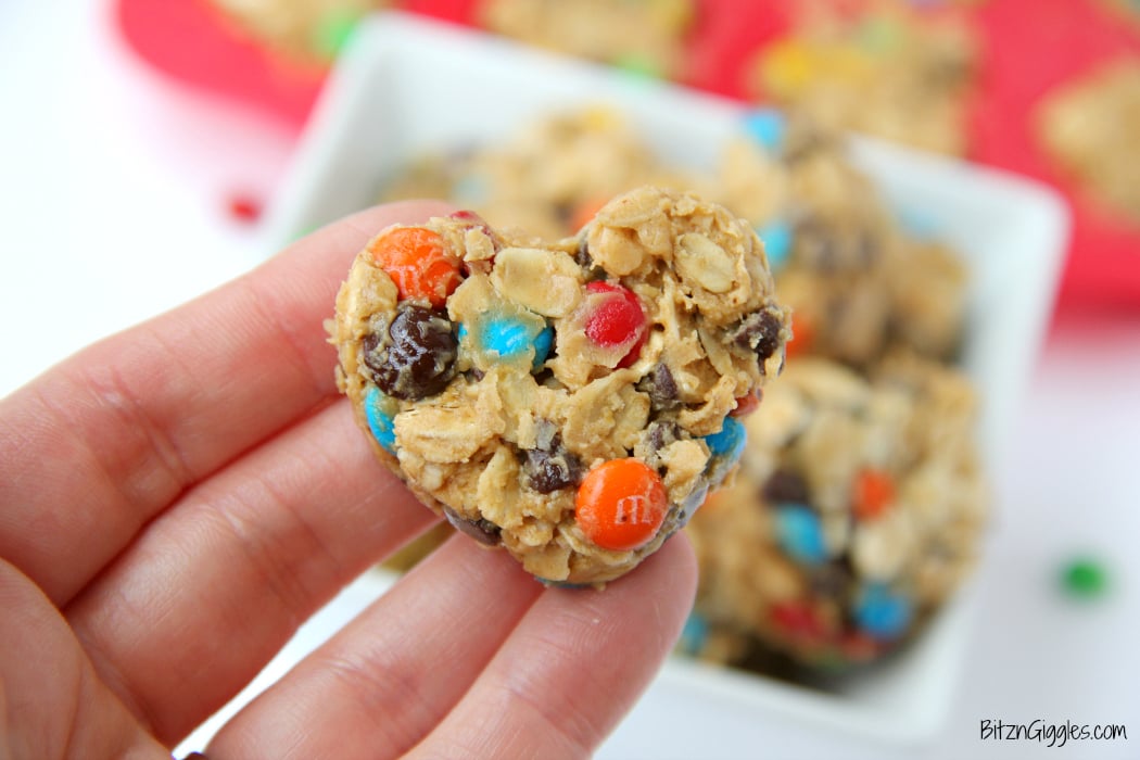 M&M Granola Bites - These granola bites are a family favorite, made with peanut butter, honey, M&Ms and chocolate chips! I used a silicone pan with heart-shaped molds to make a creative Valentine's Day dessert. Use any kind of mold you like!