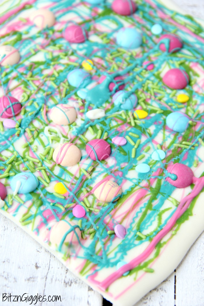 A fun twist on traditional candy bark with M&Ms, sprinkles and colored candy coating drizzle! Perfect for spring and Easter!