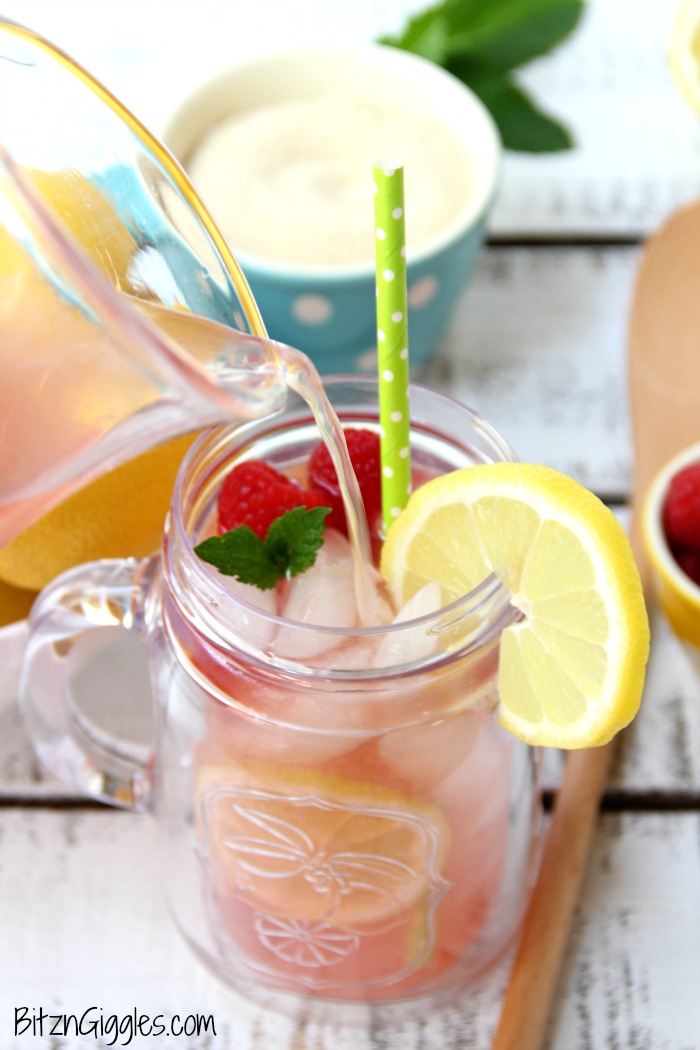 Pink Lemonade - Homemade pink lemonade made with fresh raspberries and lemons! So easy and so refreshing and delicious for a baby shower, summer party or picnic!