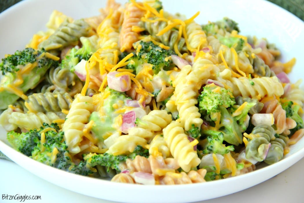 Cheddar Broccoli Pasta Salad - Broccoli, red onion, shredded cheese and rotini pasta tossed in a sweet, creamy dressing! Everyone always asks for seconds!