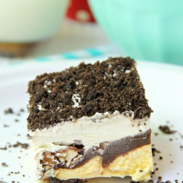Buster Bar Lasagna - Decadent layers of Oreo cookies, ice cream, hot fudge, Snickers bars and whipped topping make up this delicious 5-layer dessert!