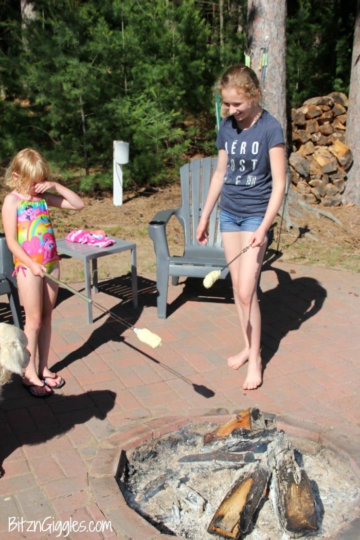 Easy Campfire Eclairs - Crescent roll dough wrapped around roasting forks, browned over the campfire, then filled with pudding and topped with chocolate frosting! Such a great camping treat!