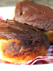 Easy Campfire Eclairs - Crescent roll dough wrapped around roasting forks, browned over the campfire, then filled with pudding and topped with chocolate frosting! Such a great camping treat!