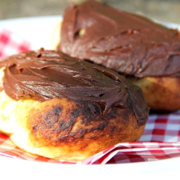 Easy Campfire Eclairs - Crescent roll dough wrapped around roasting forks, browned over the campfire, then filled with pudding and topped with chocolate frosting! Such a great camping treat!