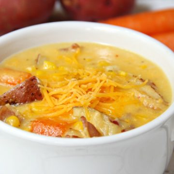 Potato Corn Chowder - Just like Grandma used to make! This flavorful combination of potatoes, corn, carrots and bacon in a creamy, cheesy broth is perfect for the whole family!