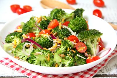 Broccoli and Tomato Salad - Sweet grape tomatoes, red onion, broccoli, cheese and sunflower seeds drizzled with a tangy raspberry vinaigrette.