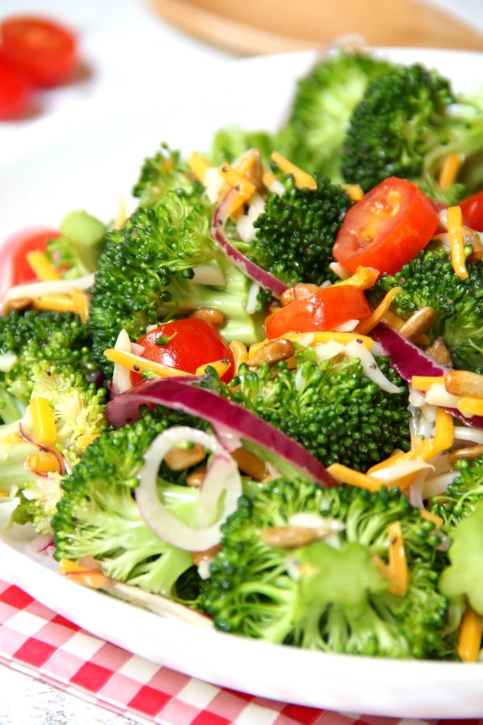 Broccoli and Tomato Salad - Sweet grape tomatoes, red onion, broccoli, cheese and sunflower seeds drizzled with a tangy raspberry vinaigrette.