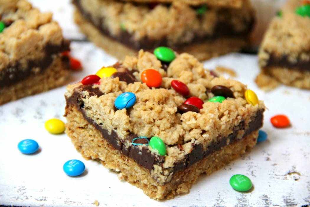 M&M Chocolate Oatmeal Bars - Chewy oatmeal bars with a chocolaty fudge layer, sprinkled with M&Ms.