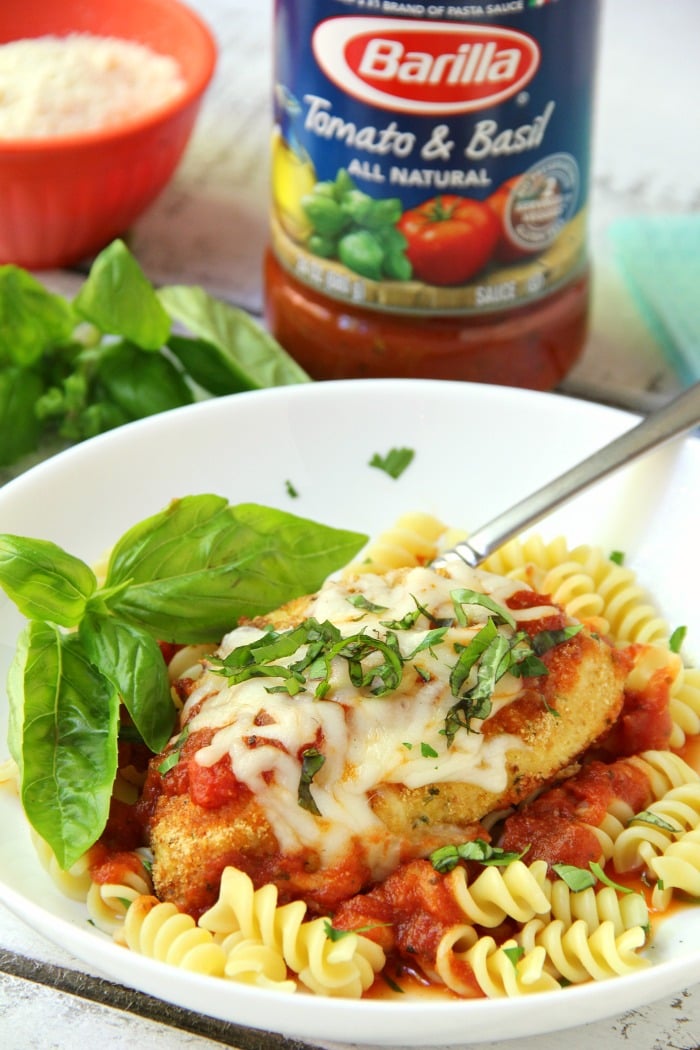 Mozzarella Basil Chicken -a delicious twist on traditional chicken parmesan. The chicken cutlets are breaded and baked, creating delicious and moist chicken to serve over pasta and sauce.