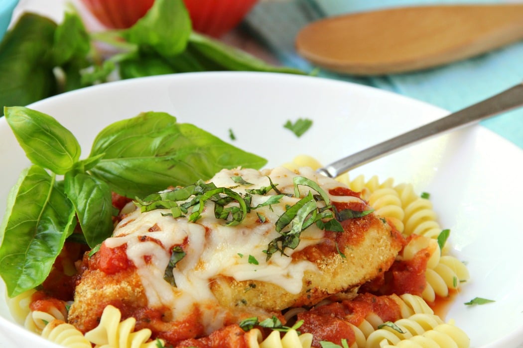 Mozzarella Basil Chicken -a delicious twist on traditional chicken parmesan. The chicken cutlets are breaded and baked, creating delicious and moist chicken to serve over pasta and sauce.