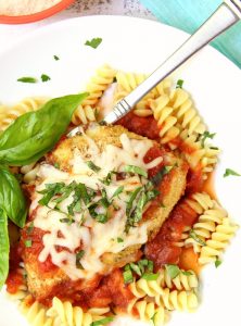 Mozzarella Basil Chicken -a delicious twist on traditional chicken parmesan. The chicken cutlets are breaded and baked, creating delicious and moist chicken to serve over pasta and sauce.