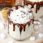 Rum & White Chocolate Hot Cocoa - a heavenly combination of white chocolate, rum, marshmallows, drizzles of chocolate and a big swirl of whipped cream topped with sprinkles is the ultimate fall indulgence!