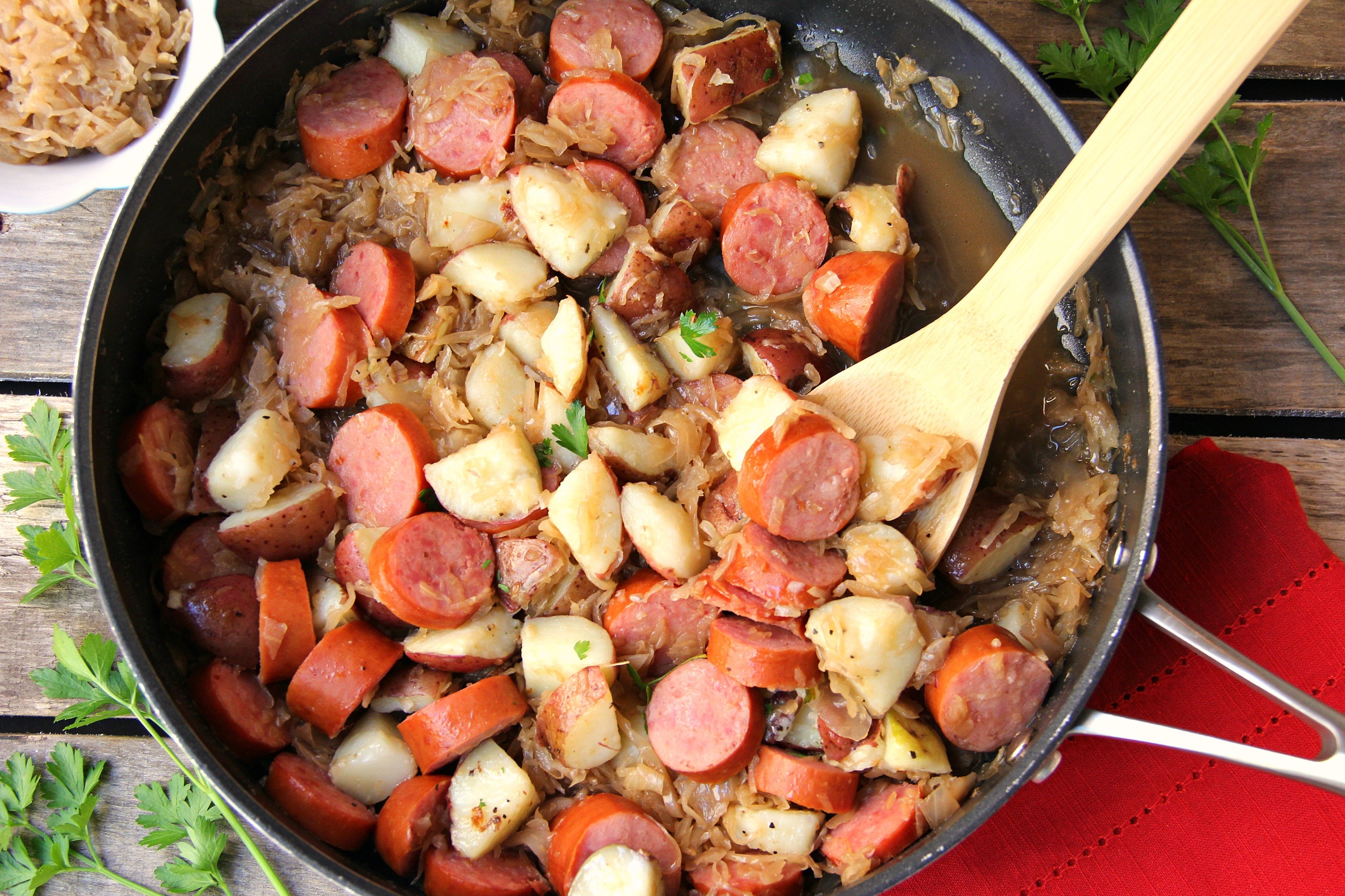 Sausage Potato Sauerkraut Skillet - Kielbasa, potatoes and Coca Cola infused sauerkraut creates a winning combination for a traditional and comforting skillet meal.