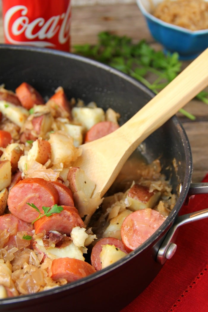 Sausage Potato Sauerkraut Skillet - Kielbasa, potatoes and Coca Cola infused sauerkraut creates a winning combination for a traditional and comforting skillet meal.