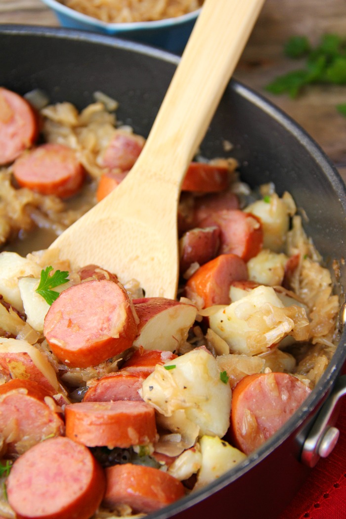 Sausage Potato Sauerkraut Skillet - Kielbasa, potatoes and Coca Cola infused sauerkraut creates a winning combination for a traditional and comforting skillet meal.