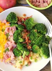 Twice Baked Potato Bowl - Baby reds are steamed, mashed, loaded with delicious toppings and then drizzled with a cheesy broccoli sauce. Tastes just like a twice baked potato but prepared in record time!