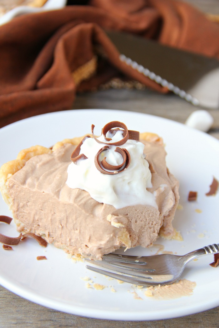 Mile High Chocolate Mousse Pie - Creamy, decadent chocolate mousse piled high and finished off with whipped cream and chocolate shavings.