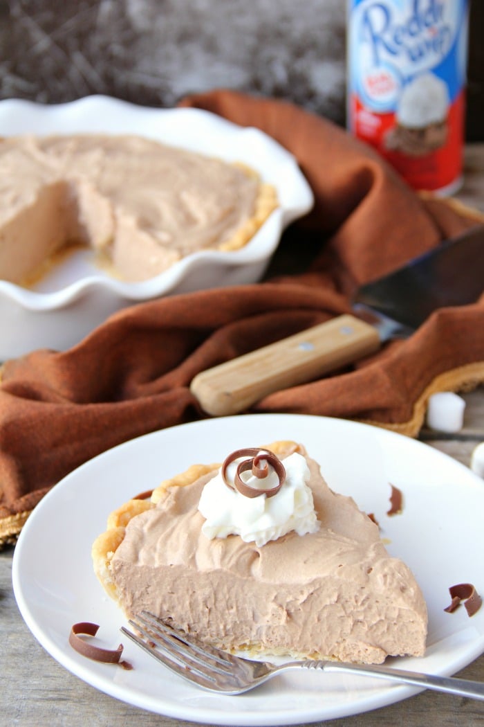 Mile High Chocolate Mousse Pie - Creamy, decadent chocolate mousse piled high and finished off with whipped cream and chocolate shavings.