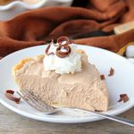 Mile High Chocolate Mousse Pie - Creamy, decadent chocolate mousse piled high and finished off with whipped cream and chocolate shavings.