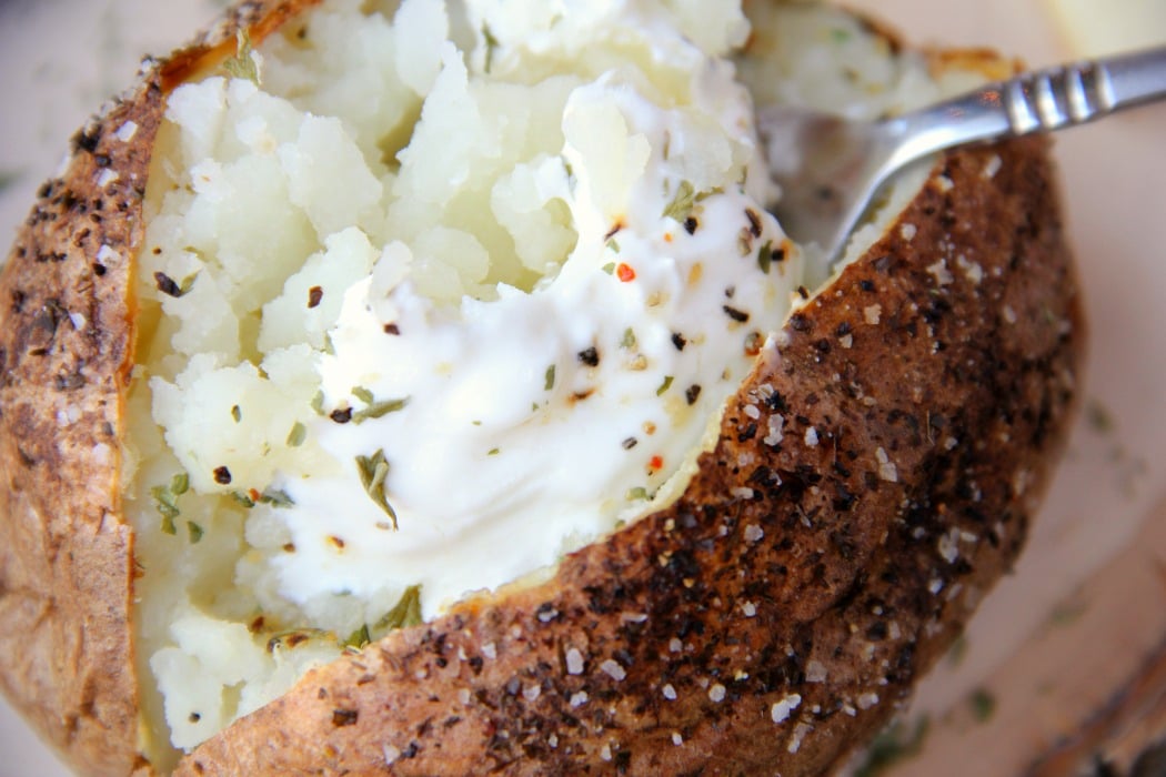 Easy Air Fryer Baked Potatoes - Tender, delicious baked potatoes with a crispy, flavorful skin. You'll never go back to microwaving or baking in the oven again!