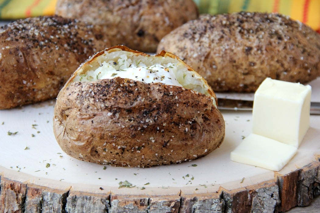 Easy Air Fryer Baked Potatoes - Tender, delicious baked potatoes with a crispy, flavorful skin. You'll never go back to microwaving or baking in the oven again!