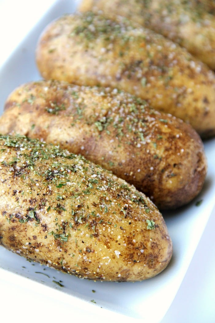 Easy Air Fryer Baked Potatoes - Tender, delicious baked potatoes with a crispy, flavorful skin. You'll never go back to microwaving or baking in the oven again!