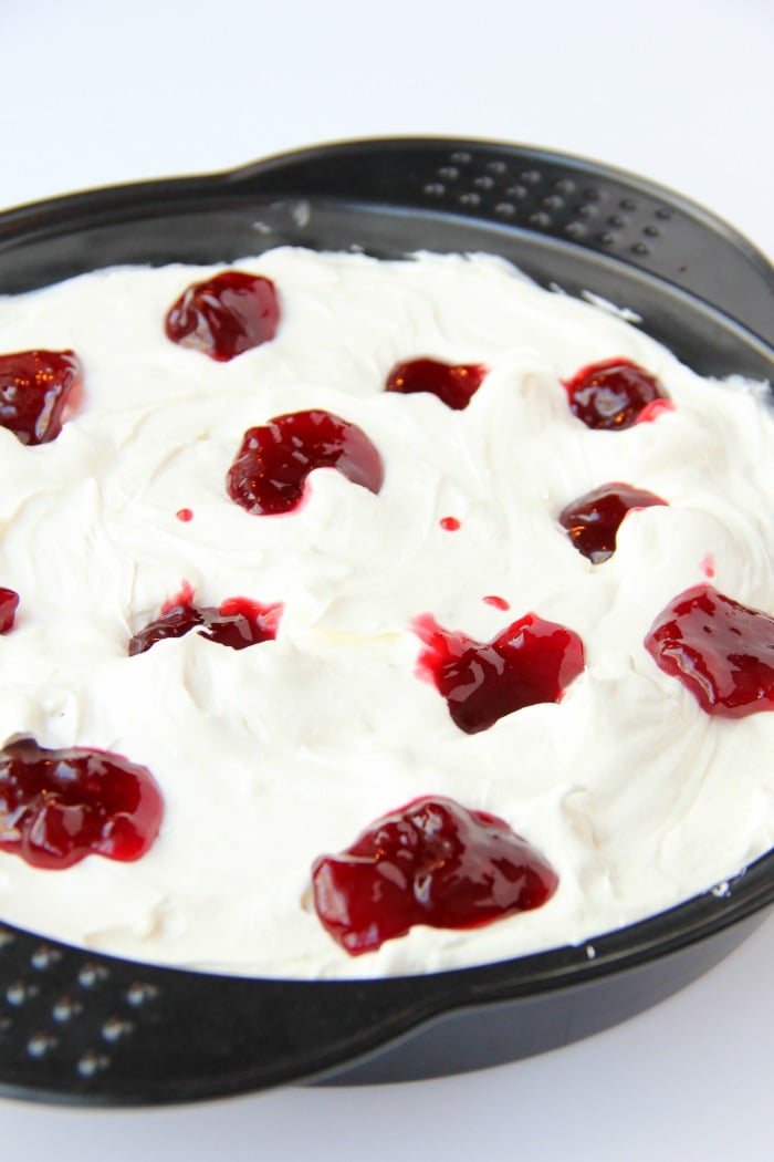 Swirled Raspberry Cheesecake -A fluffy Oreo-crust cheesecake with decadent raspberry swirls.