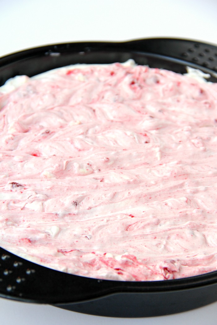 Swirled Raspberry Cheesecake -A fluffy Oreo-crust cheesecake with decadent raspberry swirls.