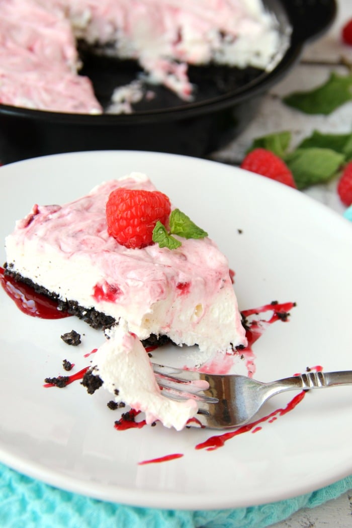 Swirled Raspberry Cheesecake -A fluffy Oreo-crust cheesecake with decadent raspberry swirls.