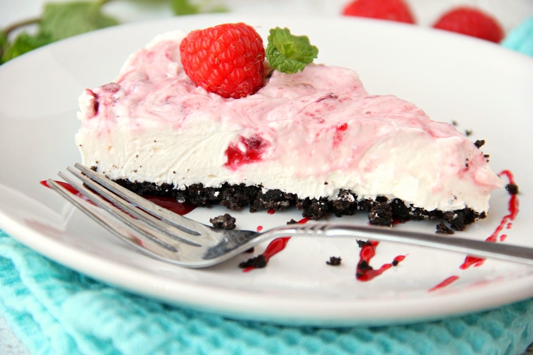 Swirled Raspberry Cheesecake -A fluffy Oreo-crust cheesecake with decadent raspberry swirls.