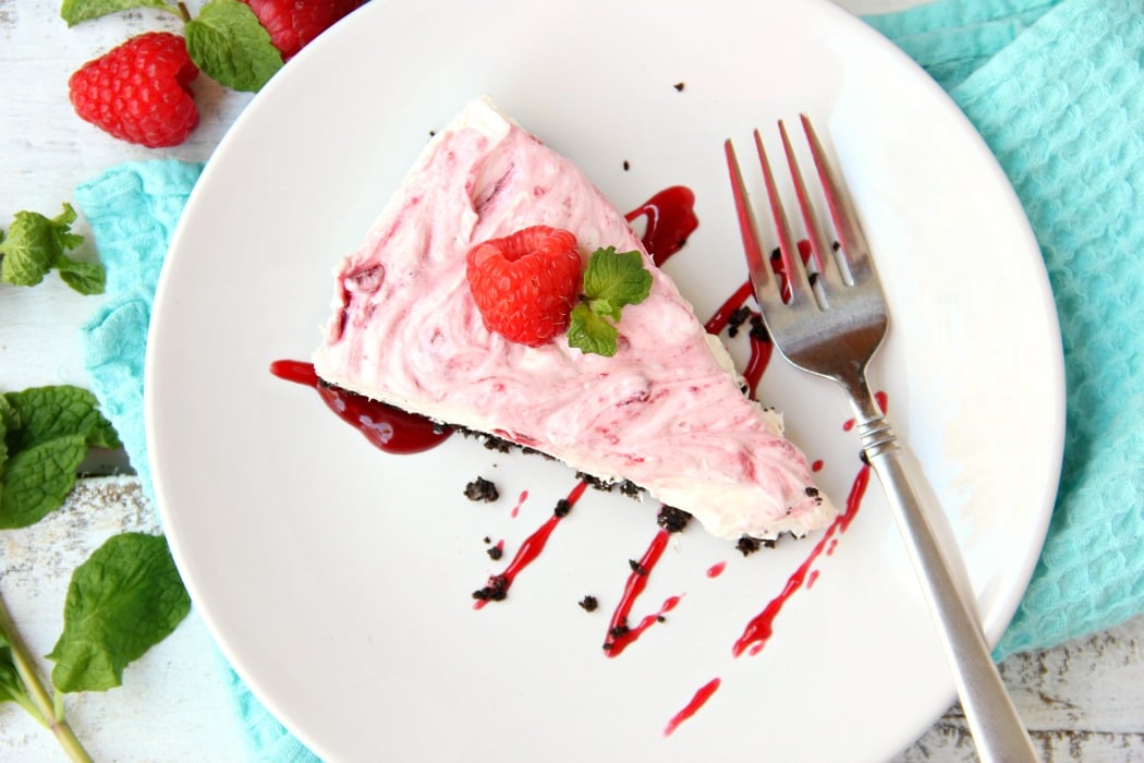 Swirled Raspberry Cheesecake -A fluffy Oreo-crust cheesecake with decadent raspberry swirls.