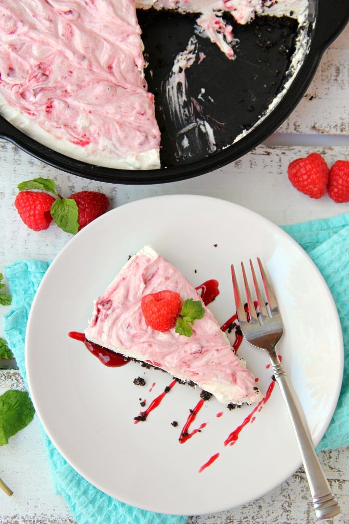 Swirled Raspberry Cheesecake -A fluffy Oreo-crust cheesecake with decadent raspberry swirls.