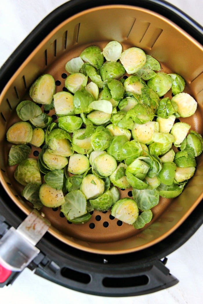 To prepare the brussels sprouts, you just want to cut off the end of the sprout, slice it in half and take off a few of the outer leaves.