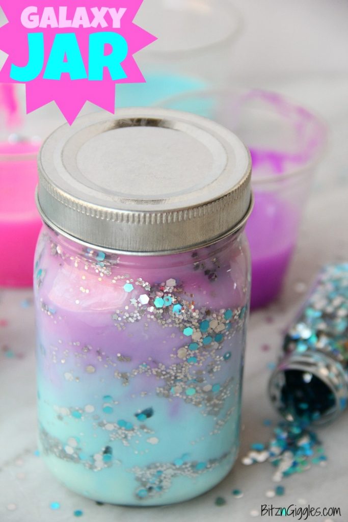 DIY Galaxy Jar -A gorgeous craft for kids, teens or even adults that love color and glitter! Simply layer cotton balls, acrylic paint, water and glitter shapes to create your own galaxy in a jar!