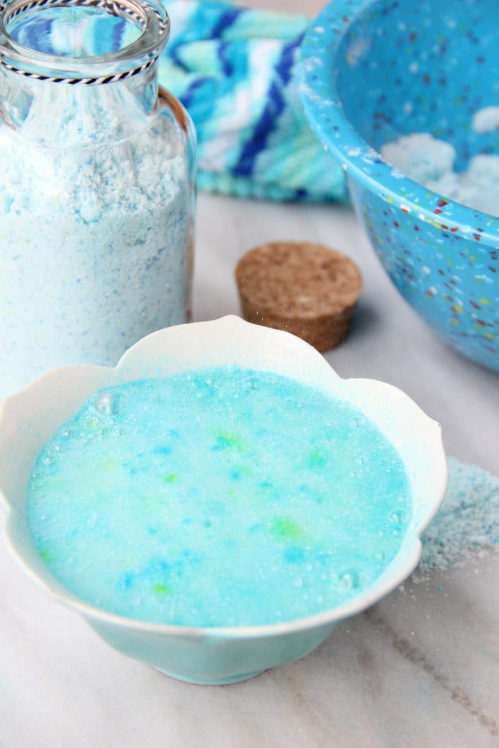 Fizzy Tropical Bath Powder - A light, airy, coconut scented powder that's calming, soothing and fizzes with pops of blue and green color when it hits the bath water, turning your water a beautiful turquoise blue.