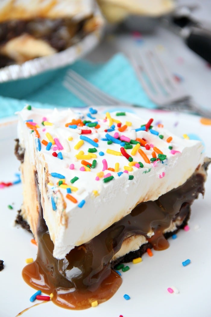 Ultimate Ice Cream Sundae Pie - Fudge and caramel topping filled ice cream pie with a fluffy whipped topping covered in sprinkles!