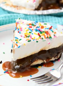 Ultimate Ice Cream Sundae Pie - Fudge and caramel topping filled ice cream pie with a fluffy whipped topping covered in sprinkles!