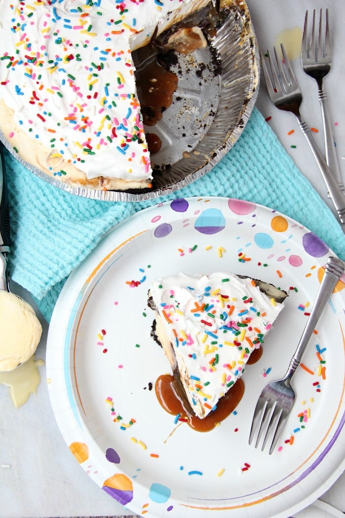 Ultimate Ice Cream Sundae Pie - Fudge and caramel topping filled ice cream pie with a fluffy whipped topping covered in sprinkles!