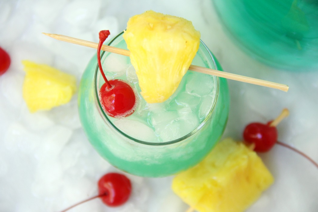 Green Hawaiian Cocktail - a beautiful and refreshing combination of vodka, coconut rum, blue curacao, pineapple juice and lemon-lime soda. It's the perfect drink for summer!