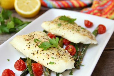Sheet Pan Cod - A simple one-sheet recipe that features light, flaky cod alongside colorful asparagus and tomatoes. Lemon pepper, fresh lemon juice and grated Parmesan cheese top off the dish.