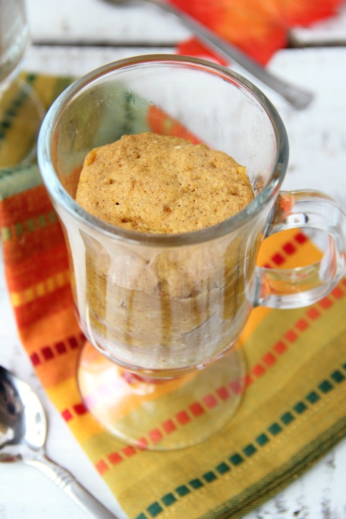 Pumpkin Mug Cake - A quick and easy microwave pumpkin mug cake. Topped with whipped cream and a cinnamon stick, this is the ultimate simple fall dessert!