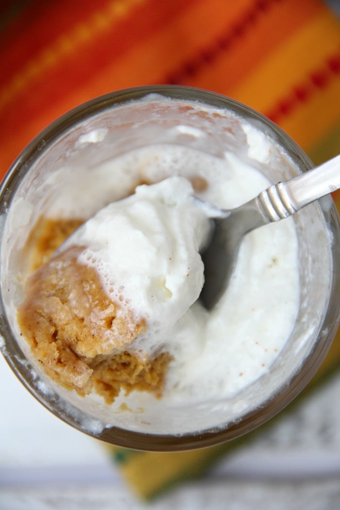 Pumpkin Mug Cake - A quick and easy microwave pumpkin mug cake. Topped with whipped cream and a cinnamon stick, this is the ultimate simple fall dessert!