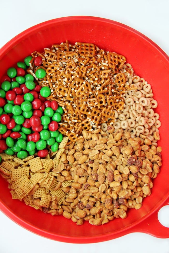 Easy Reindeer Chow - A delicious snack mix filled with pretzels, peanuts, Cheerios, Chex and M&Ms covered in white chocolate. Great for snacking and gift giving!